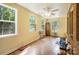 Sunny sunroom featuring multiple windows, a ceiling fan, and brick accent wall at 3116 Old Montgomery Place Rd, Monroe, NC 28112