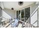 Covered back porch featuring striped chairs, ceiling fans, and sliding glass doors at 31226 Cove View Ct, Lancaster, SC 29720