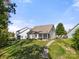 Spacious backyard with lush green lawn and a stone pathway leading to the house at 31226 Cove View Ct, Lancaster, SC 29720