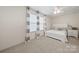 Comfortable bedroom with two large windows, neutral walls, and a white queen bed at 31226 Cove View Ct, Lancaster, SC 29720