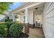 Charming covered front porch with brick accents and neatly trimmed landscaping at 31226 Cove View Ct, Lancaster, SC 29720