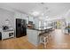 Open kitchen featuring a large island with seating, stainless steel appliances, and stylish pendant lighting at 31226 Cove View Ct, Lancaster, SC 29720