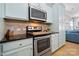 Modern kitchen featuring stainless steel appliances, light blue cabinets, and ample counter space at 31226 Cove View Ct, Lancaster, SC 29720