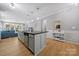 Open concept kitchen with a large island, stainless steel dishwasher, and adjacent living area at 31226 Cove View Ct, Lancaster, SC 29720