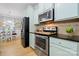 Bright kitchen with stainless steel appliances, light blue cabinetry, and a view into the dining area at 31226 Cove View Ct, Lancaster, SC 29720