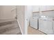 Bright laundry area with a washer, dryer, and overhead cabinets conveniently located near the staircase at 31226 Cove View Ct, Lancaster, SC 29720