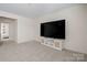 Open-concept living room with a large TV mounted on a white cabinet with woven accents at 31226 Cove View Ct, Lancaster, SC 29720