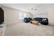 Spacious bonus room with large sectional, neutral walls, and bright lighting at 31226 Cove View Ct, Lancaster, SC 29720