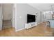 Spacious living area with hardwood flooring, staircase, and TV entertainment center at 31226 Cove View Ct, Lancaster, SC 29720
