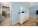 Bright primary bedroom with walk-in shower, light blue walls, and a white wood dresser at 31226 Cove View Ct, Lancaster, SC 29720