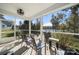 Relaxing screened porch with comfortable seating, ceiling fan and serene views of the surrounding lake and trees at 31226 Cove View Ct, Lancaster, SC 29720
