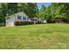 Spacious backyard with mature trees and lush green lawn, home, camper and utility building at 370 Shiloh Rd, Statesville, NC 28677