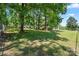 Large backyard with mature trees, grass, and partial fencing at 370 Shiloh Rd, Statesville, NC 28677