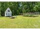 Landscaped backyard features garden, shed and fire pit area perfect for outdoor entertaining at 370 Shiloh Rd, Statesville, NC 28677