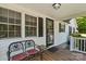 Inviting front porch with seating, black shutters, and a glass front door providing curb appeal at 370 Shiloh Rd, Statesville, NC 28677