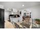 A kitchen area features white cabinets, black appliances, and a glass-top dining table at 370 Shiloh Rd, Statesville, NC 28677