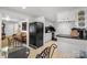 A functional eat-in kitchen boasts white cabinets, a black refrigerator, and a glass-top table at 370 Shiloh Rd, Statesville, NC 28677