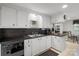 Bright kitchen features sleek black countertops, white cabinetry, and modern appliances at 370 Shiloh Rd, Statesville, NC 28677
