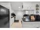 Kitchen boasts white cabinets, a black refrigerator, and a practical counter top surface at 370 Shiloh Rd, Statesville, NC 28677