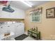 Well-lit laundry room features modern washer and dryer, storage cabinets, and decorated window at 370 Shiloh Rd, Statesville, NC 28677