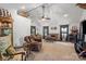 Bright living room with vaulted ceilings, neutral carpet, a ceiling fan and many decor items at 370 Shiloh Rd, Statesville, NC 28677