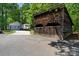 Rustic utility building with garage doors, near a home, camper, and two-car garage at 370 Shiloh Rd, Statesville, NC 28677