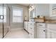Bright bathroom featuring a double vanity with stone countertops, white cabinets, and a glass shower at 371 Luray Way, Rock Hill, SC 29730