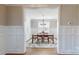 Dining room featuring wainscoting, hardwood floors, a chandelier, and large window with blind at 371 Luray Way, Rock Hill, SC 29730
