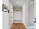 Inviting entryway featuring a built-in bench, coat rack, and stylish wood-look flooring at 371 Luray Way, Rock Hill, SC 29730