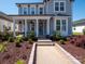Charming two-story home featuring a welcoming front porch with a swing and a well-manicured landscaped yard at 371 Luray Way, Rock Hill, SC 29730