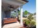 Inviting front porch with a comfortable swing, ceiling fans, and hanging plants, surrounded by lush landscaping at 371 Luray Way, Rock Hill, SC 29730