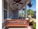 Inviting front porch with a comfortable swing, ceiling fans, and hanging plants, creating a relaxing outdoor space at 371 Luray Way, Rock Hill, SC 29730