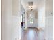 Bright hallway featuring hardwood floors, wainscoting, and a view of the front door with wreath at 371 Luray Way, Rock Hill, SC 29730