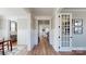 Hallway with wood floors, wainscoting, and views of the kitchen and dining area, showcasing the home's layout at 371 Luray Way, Rock Hill, SC 29730