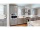Well-equipped kitchen featuring gray cabinets, stainless steel appliances, and sleek hardwood flooring at 371 Luray Way, Rock Hill, SC 29730