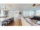 Open-concept living room and kitchen with hardwood floors, white sofa, and island with seating at 371 Luray Way, Rock Hill, SC 29730