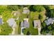 Aerial view of a property with lush greenery, mature trees, and well-maintained landscaping at 374 Queens Sw Dr, Concord, NC 28025