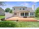 Backyard featuring a large deck, well-maintained lawn, and mature trees at 374 Queens Sw Dr, Concord, NC 28025