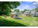 Large, green backyard featuring a deck off the main house and a small outbuilding at 374 Queens Sw Dr, Concord, NC 28025