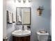 Cozy bathroom with classic sink, vanity, mirror and decorative features at 374 Queens Sw Dr, Concord, NC 28025
