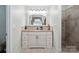 Bathroom features a neutral vanity with granite countertop, and tile shower, seamlessly blending style and functionality at 374 Queens Sw Dr, Concord, NC 28025