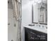 The sleek bathroom features a modern vanity with stone countertop and patterned curtain at 374 Queens Sw Dr, Concord, NC 28025