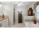 This bathroom boasts double sinks, a shower, and a luxurious soaking tub at 374 Queens Sw Dr, Concord, NC 28025