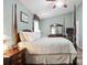 Calm bedroom with a four post bed, soft lighting, and a dark wood dresser at 374 Queens Sw Dr, Concord, NC 28025