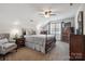 This bedroom features neutral colored walls, dark furniture and a ceiling fan at 374 Queens Sw Dr, Concord, NC 28025