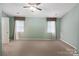 Inviting bedroom features neutral walls, carpet flooring, and natural light from the windows at 374 Queens Sw Dr, Concord, NC 28025