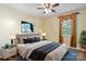 A bedroom features an upholstered headboard, side tables with lamps, and an accent window at 374 Queens Sw Dr, Concord, NC 28025