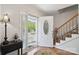 Inviting foyer with hardwood floors, staircase, and an ornate front door at 374 Queens Sw Dr, Concord, NC 28025