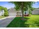 Charming home with an attached garage and a meticulously maintained lawn and garden at 374 Queens Sw Dr, Concord, NC 28025