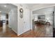 Inviting hallway with hardwood floors leading to a cozy living room with ample natural light at 374 Queens Sw Dr, Concord, NC 28025
